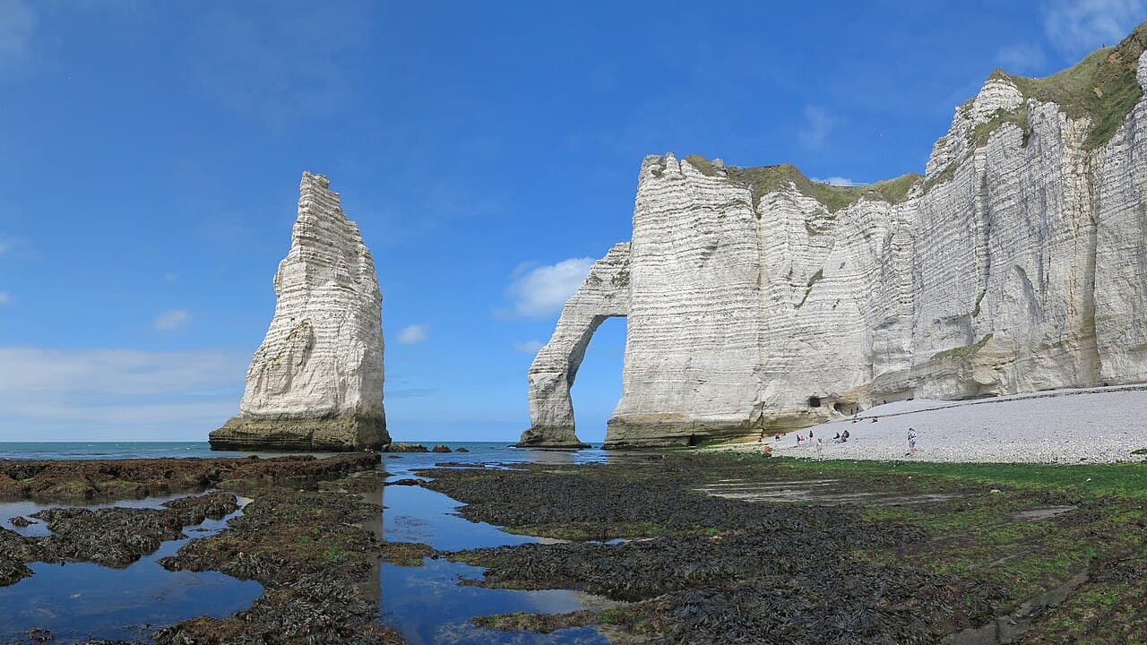 The Aiguille needle and the Porte d'Aval natural arch in the white cliffs of Étretat